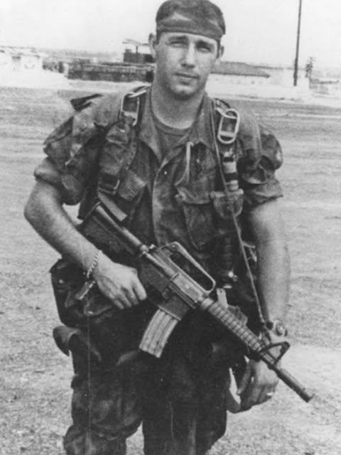 Black and white reference photo of a young soldier in fatigues used for a portrait commission